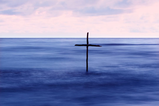 wooden cross in Jordan River